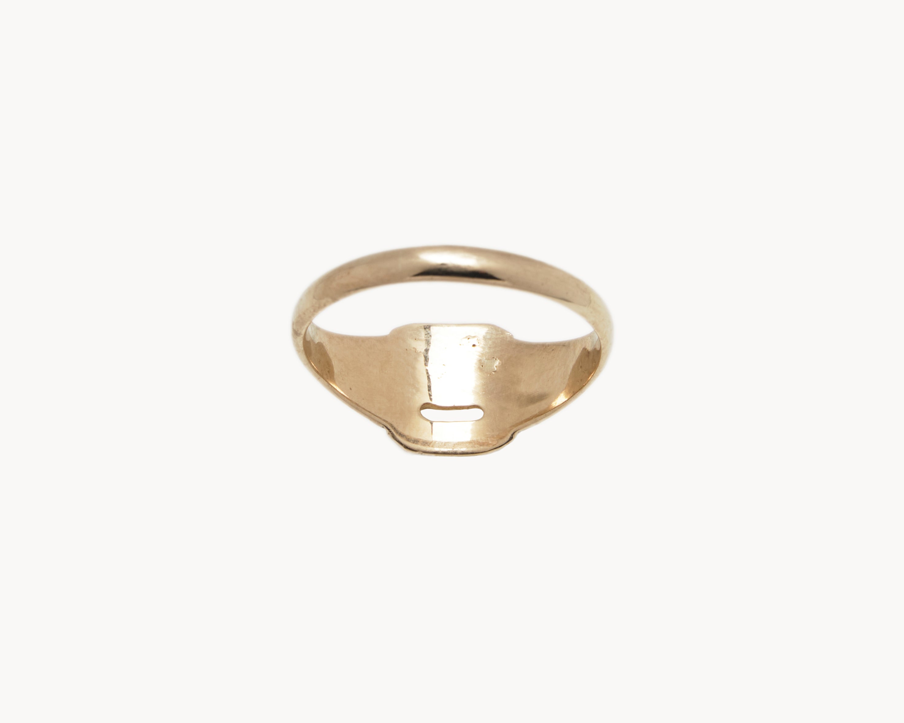 Vintage signet ring reworked with etched face, back view. 