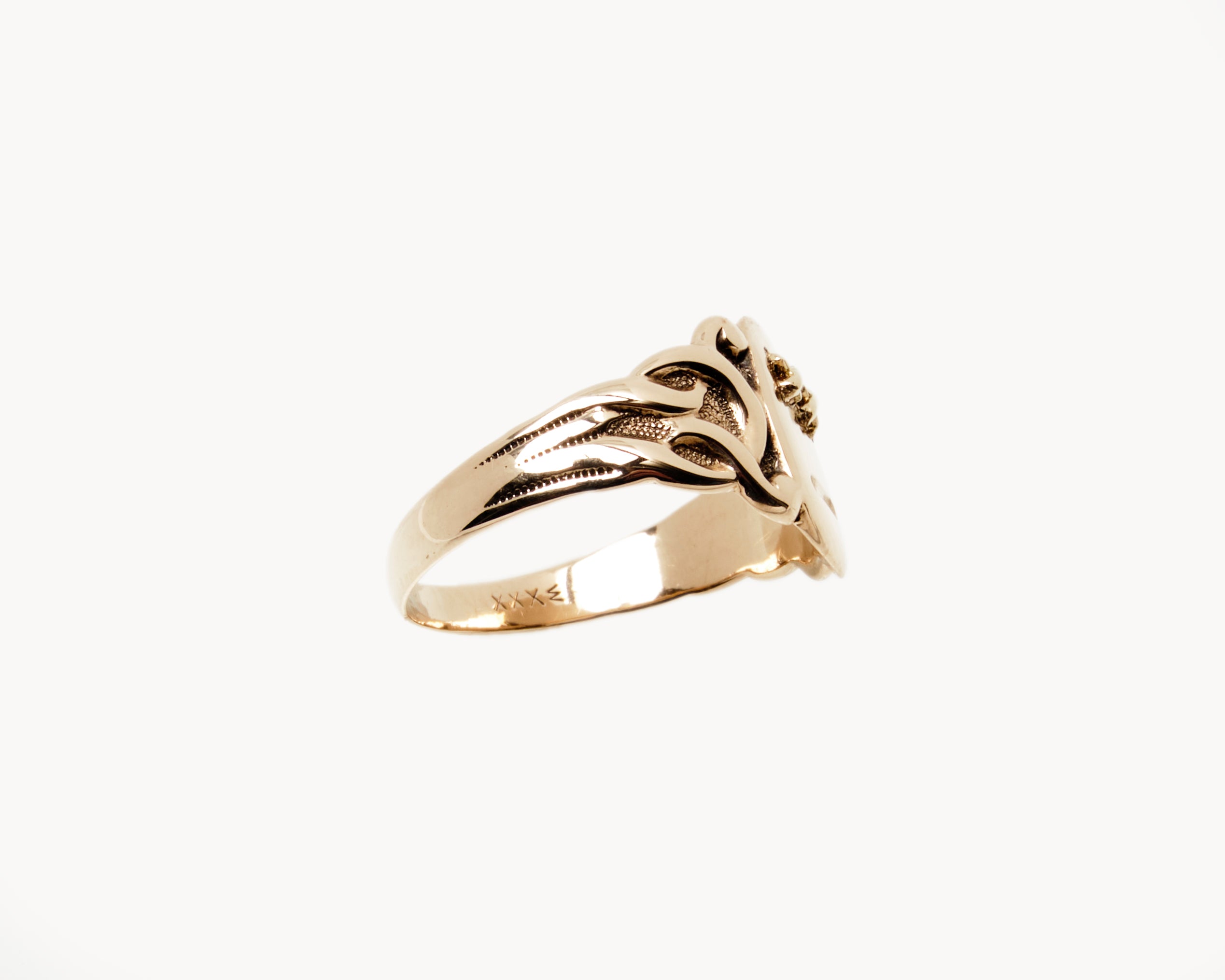 Vintage signet ring reworked with etched face, side view. 