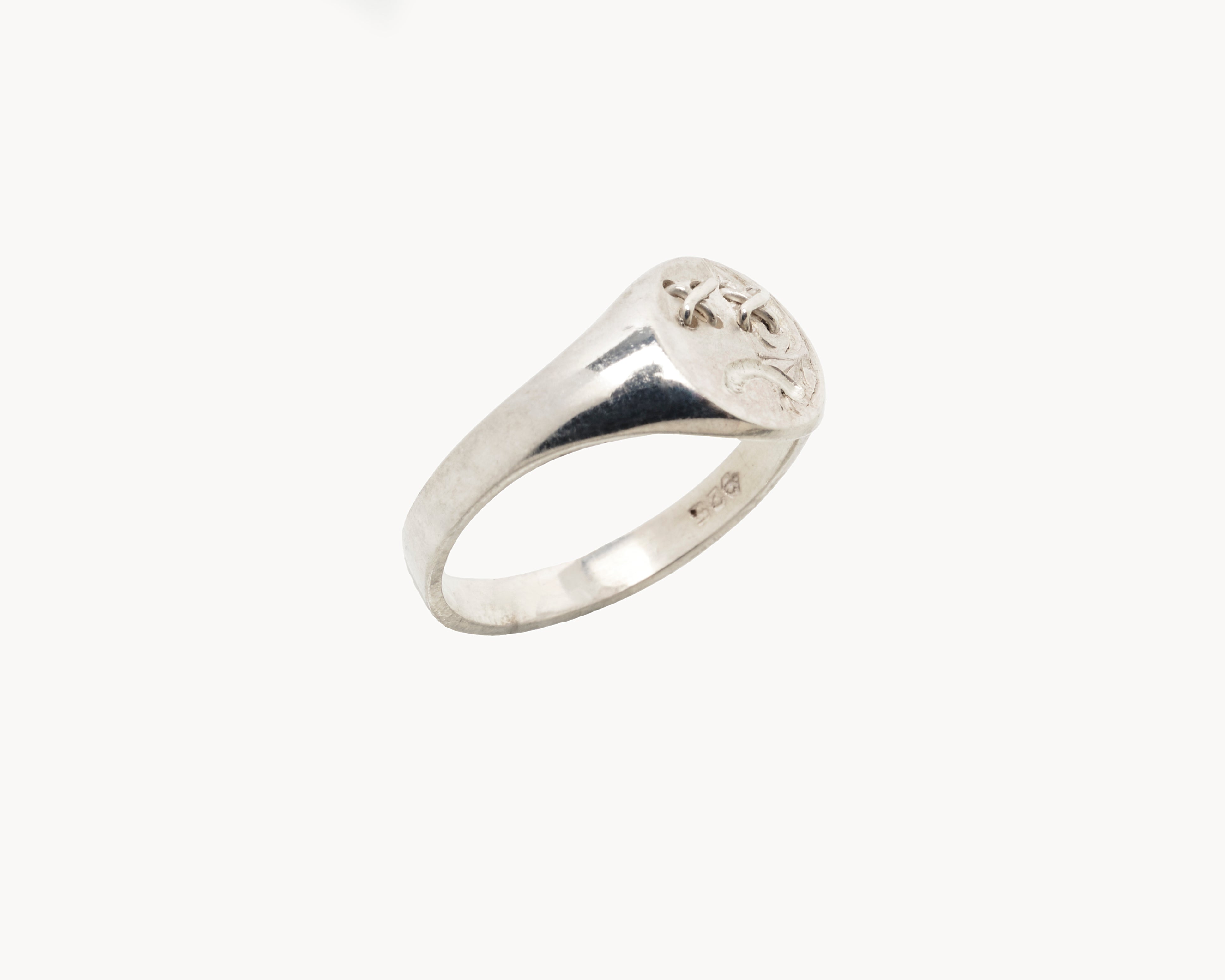 Vintage signet ring reworked with etched face, side view. 