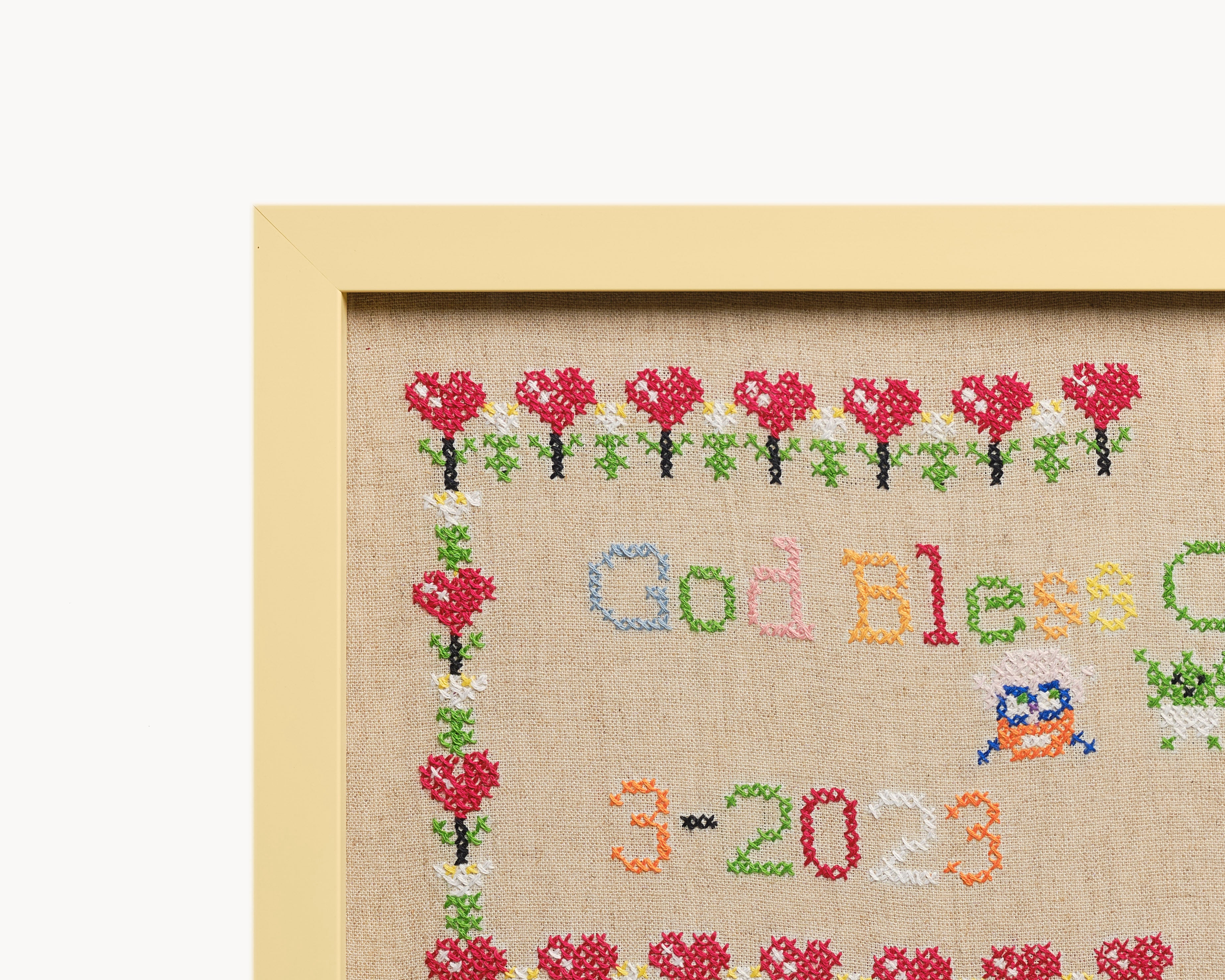 Upcycled framed sampler, close up view 