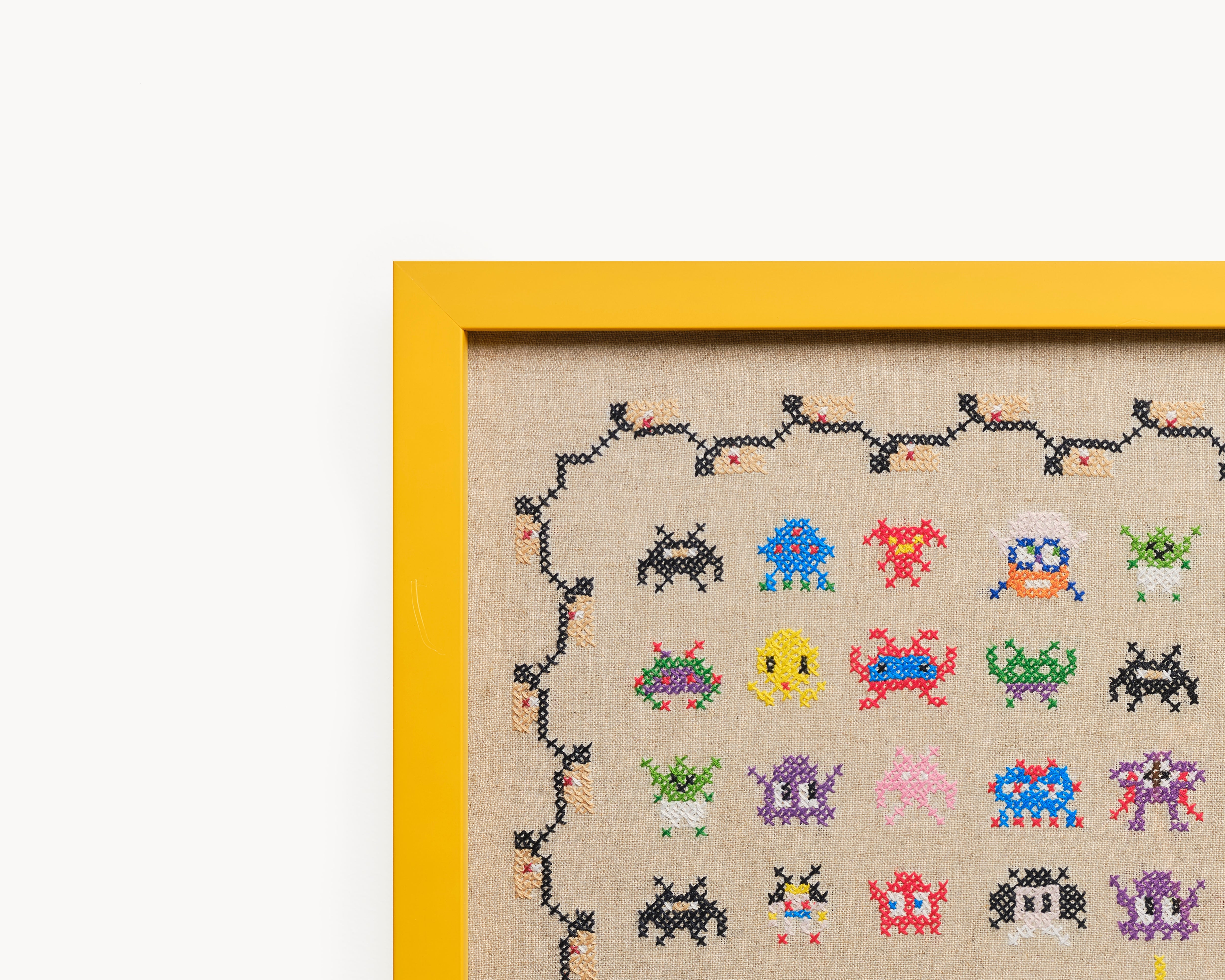 Upcycled framed sampler, close up view 
