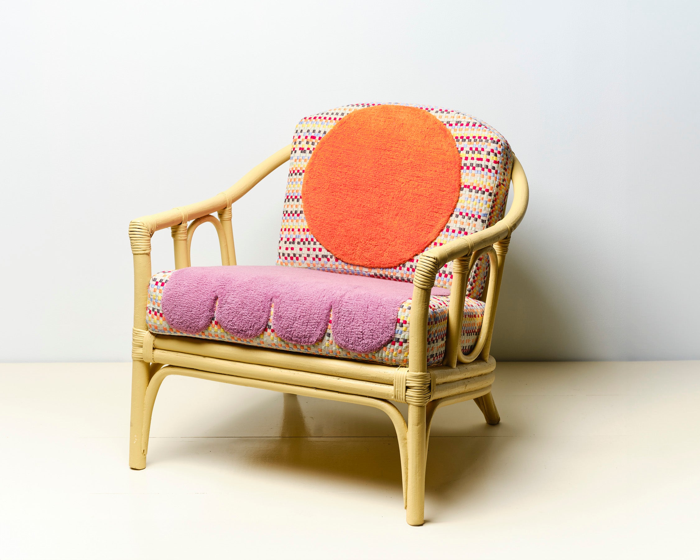 Upcycled chair with tufted and embroidered embellishments, front view 