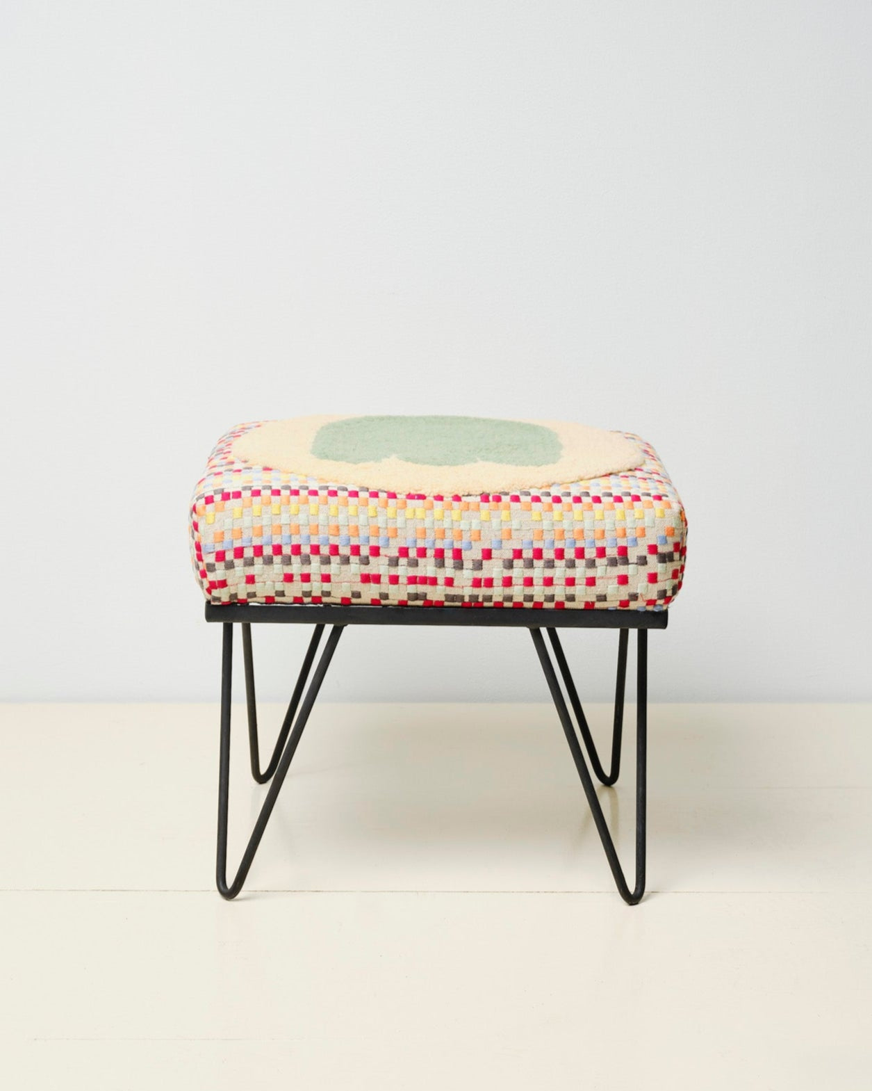 Upcycled footstool with tufted embellishments, font view 