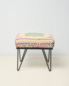 Upcycled footstool with tufted embellishments, font view 
