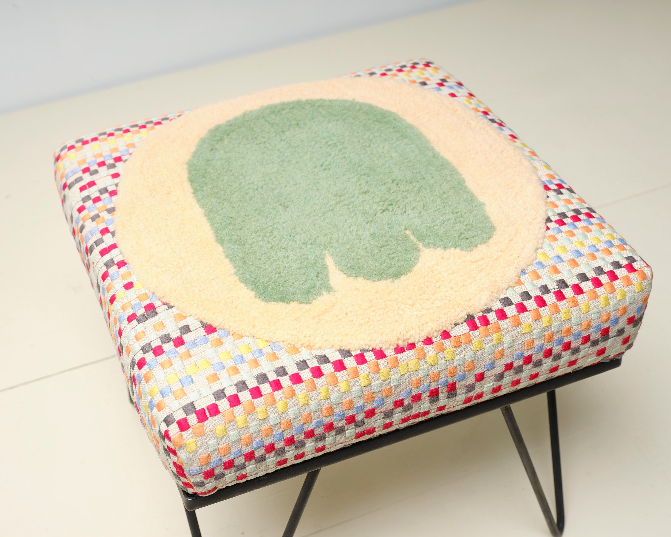 Upcycled footstool with tufted embellishments, top view 