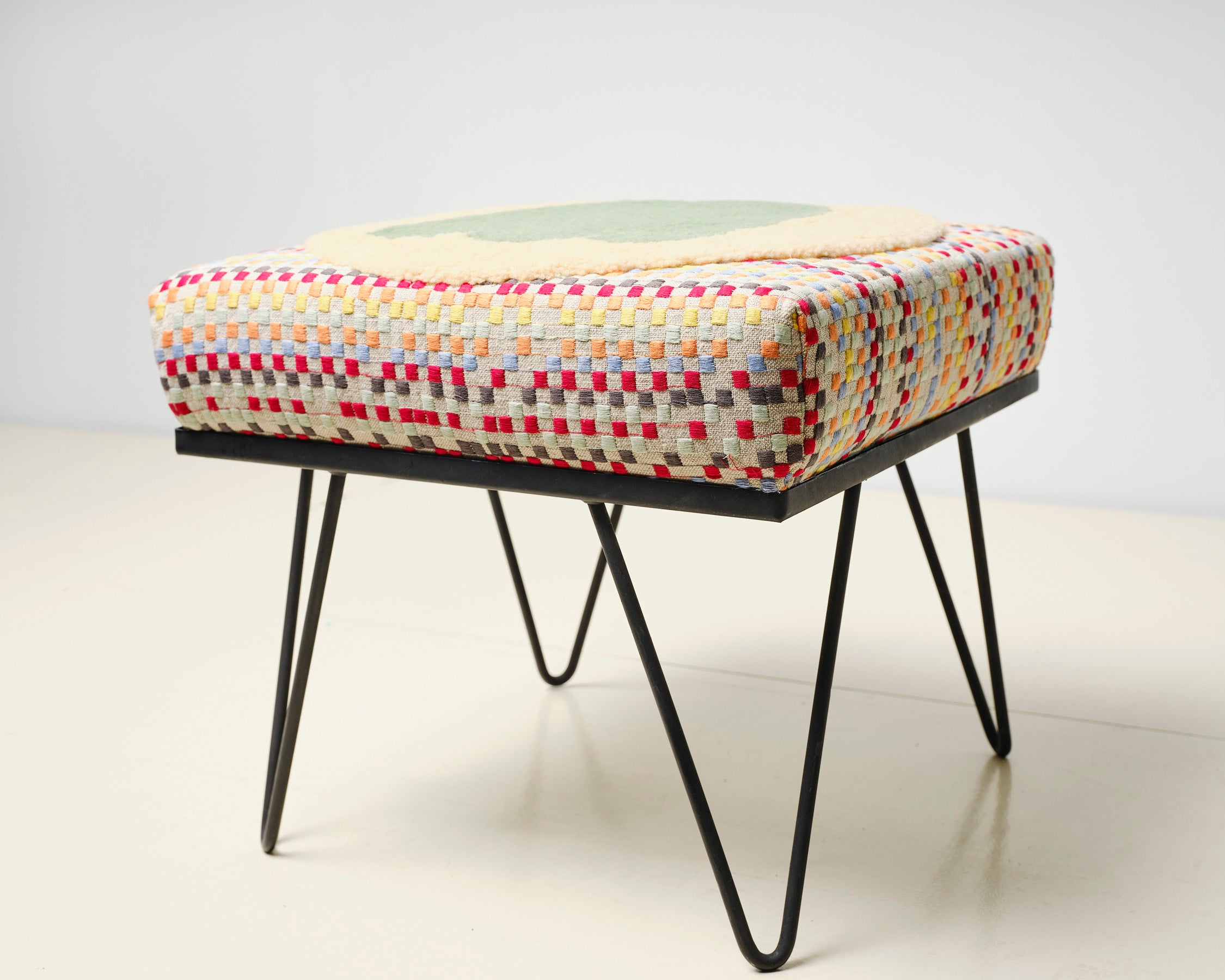 Upcycled footstool with tufted embellishments, side view 