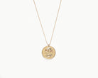 Upcycled necklace with gold plated quarter, close up view  