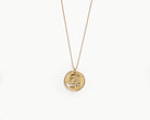 Upcycled necklace with gold plated quarter, close up view  