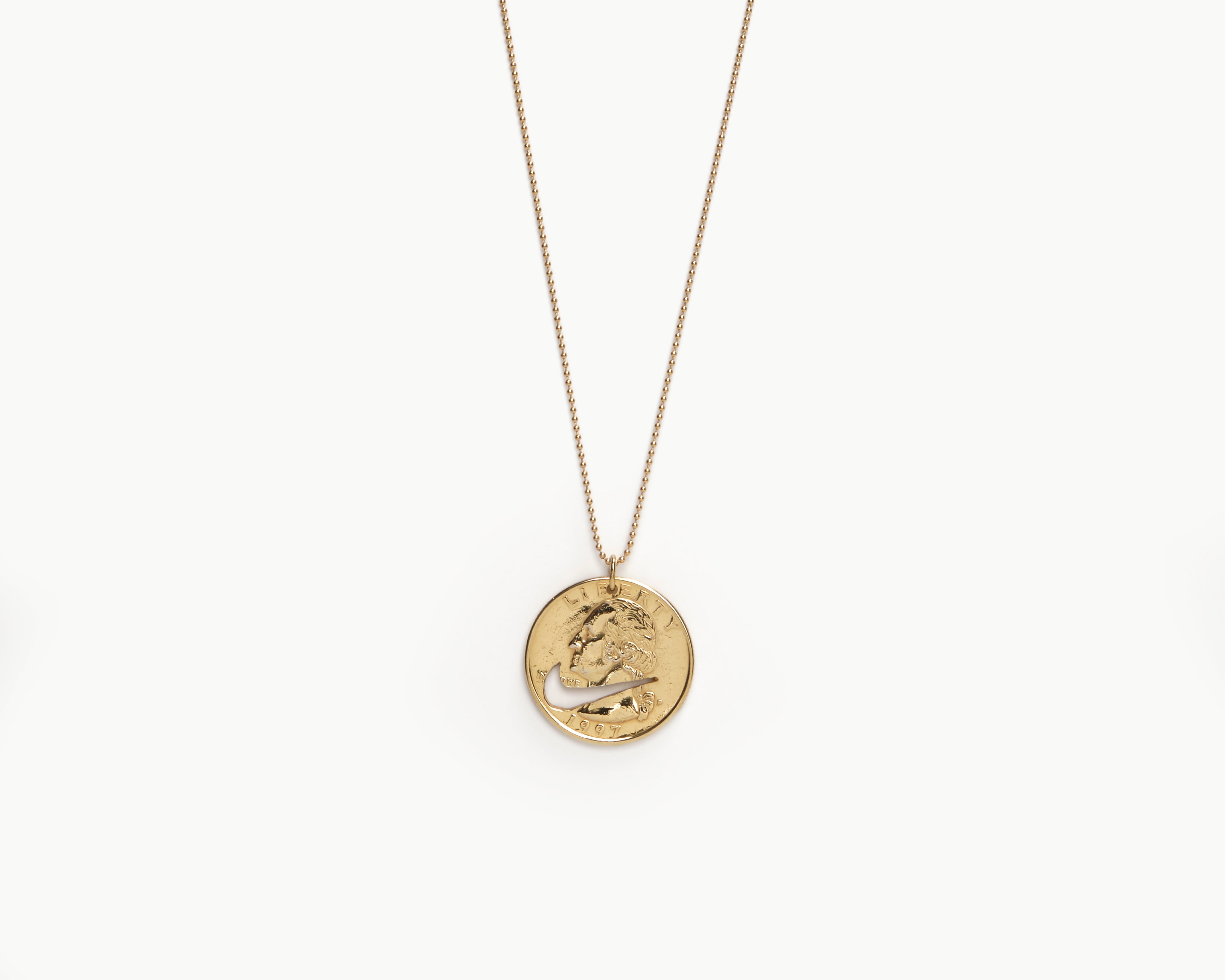 Upcycled necklace with gold plated quarter, close up view  