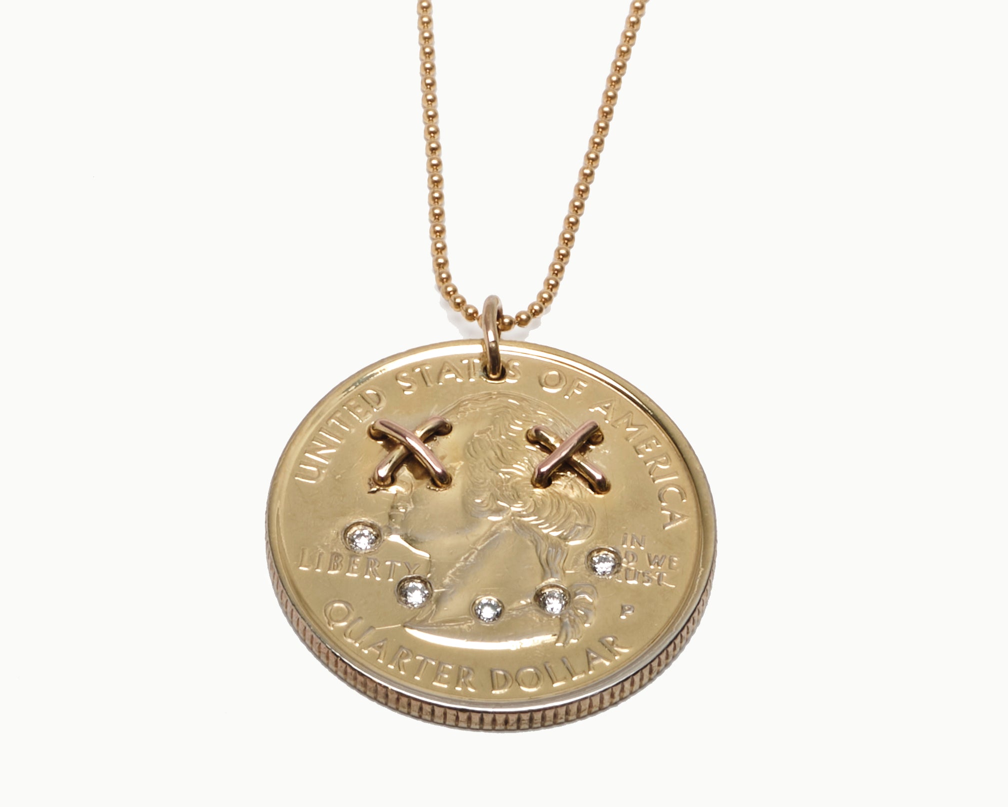 Upcycled necklace with gold plated quarter with diamond smile, close up view  