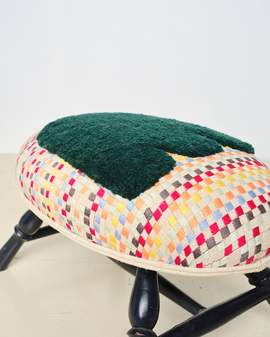 Upcycled footstool with tufted embellishments, close up view 