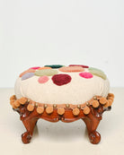 Upcycled footstool with tufted embellishments, font view 