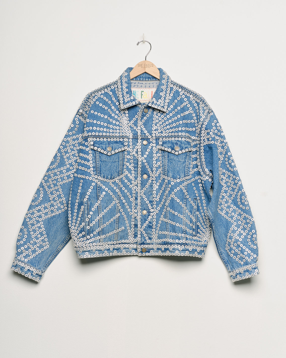 Upcycled denim jacket with pearly buttons, front view.
