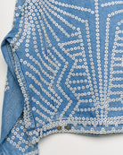 Upcycled denim jacket with pearly buttons, back close up view.