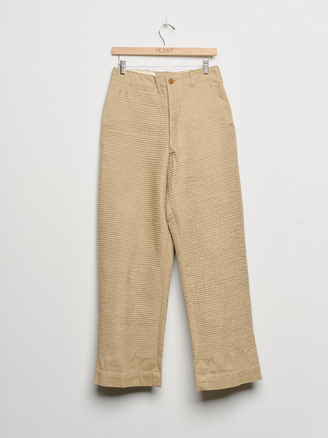 Upcycled chinos with embroidery, front view. 