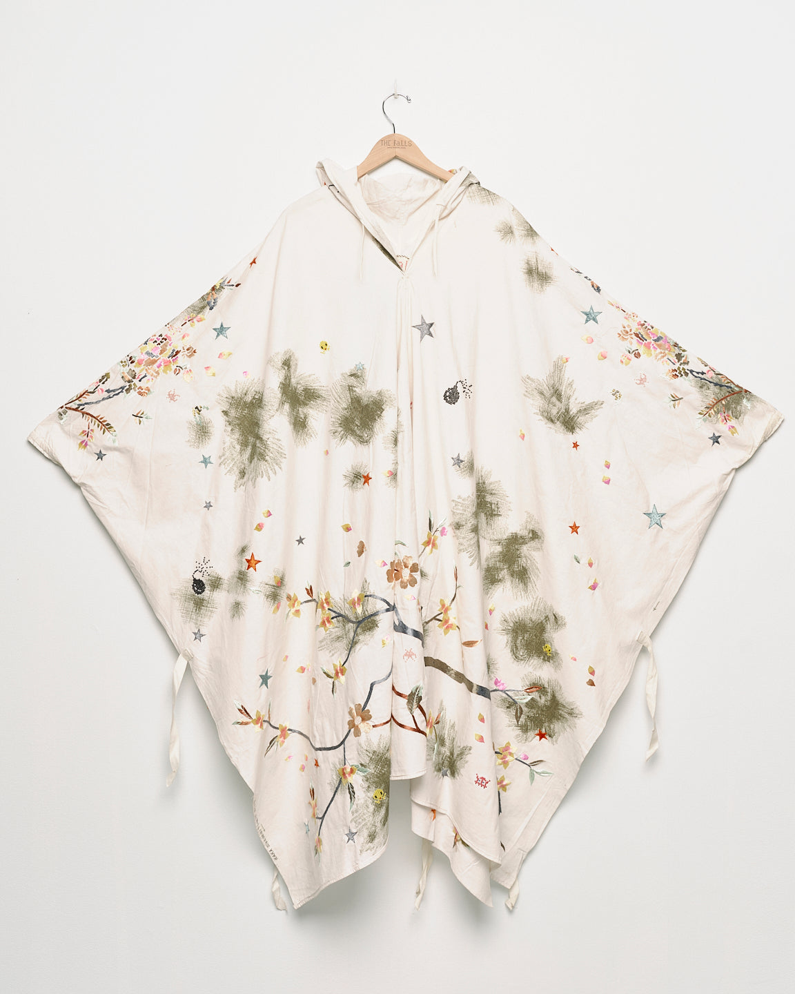 Upcycled floral snow camo hand embroidered poncho, front view. 