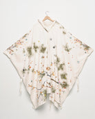 Upcycled floral snow camo hand embroidered poncho, front view. 