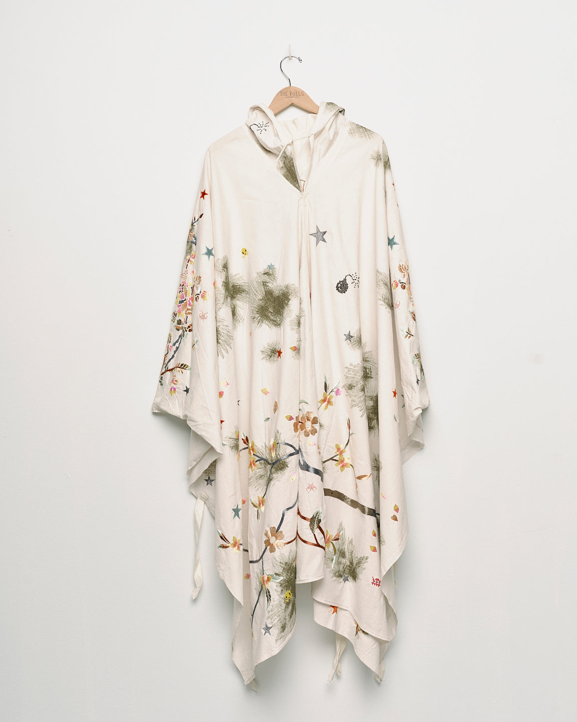 Upcycled floral snow camo hand embroidered poncho, front view. 