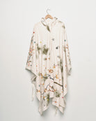 Upcycled floral snow camo hand embroidered poncho, front view. 