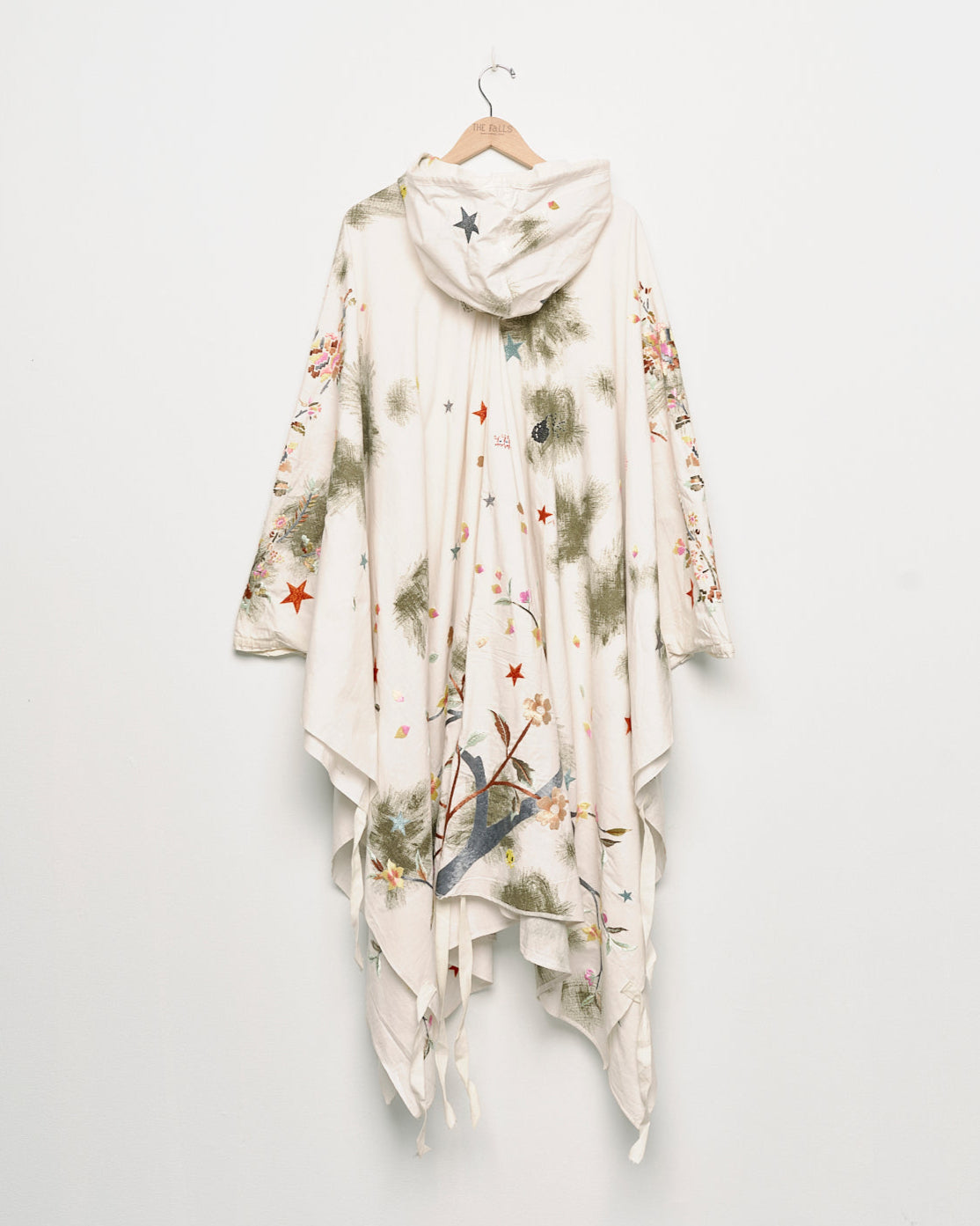 Upcycled floral snow camo hand embroidered poncho, back view. 