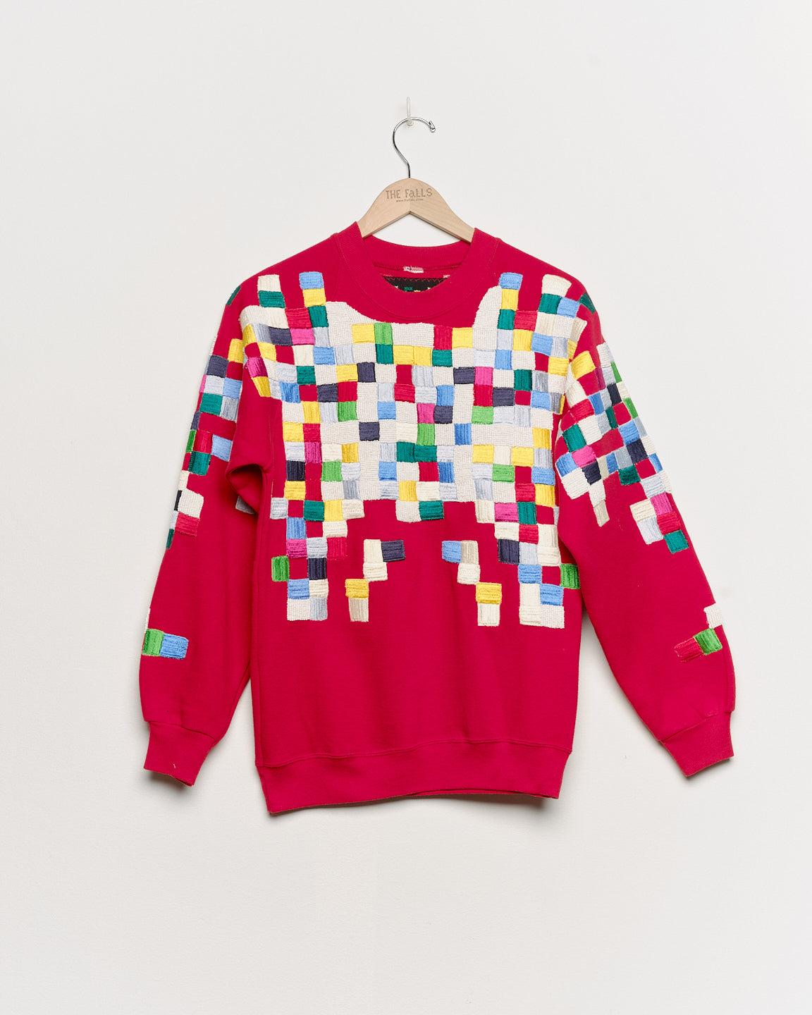 Upcycled sweatshirt with geometric embroidery, front view. 