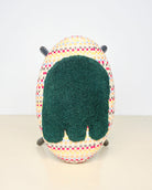 Upcycled footstool with tufted embellishments, top view 