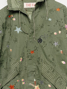 Upcycled parka with floral embroidery, close up view. 