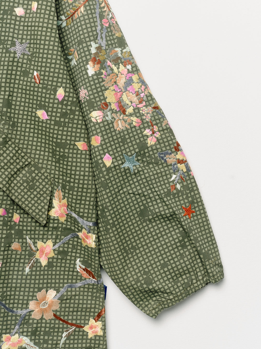 Upcycled parka with floral embroidery, close up view. 