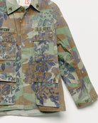 Vintage camouflage fatigue jacket with embroidered, close up view.