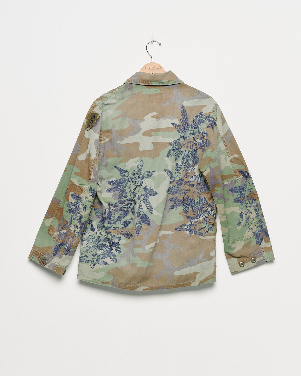 Vintage camouflage fatigue jacket with embroidered, back view.
