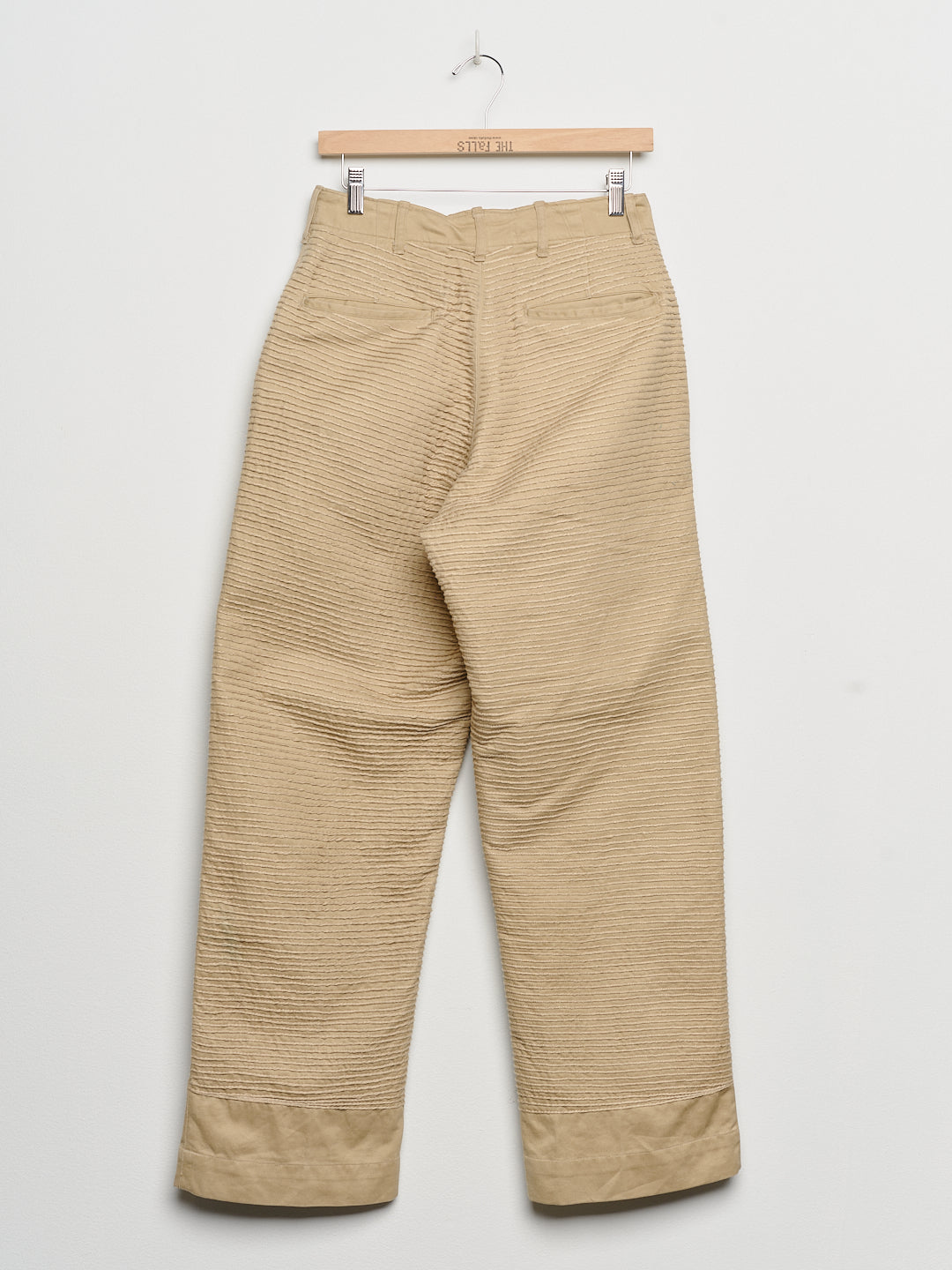 Upcycled chinos with embroidery, back view. 