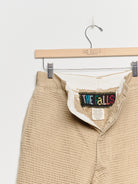 Upcycled chinos with embroidery, close up view. 