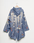 Upcycled parka with star and bomb embroidery, back view. 