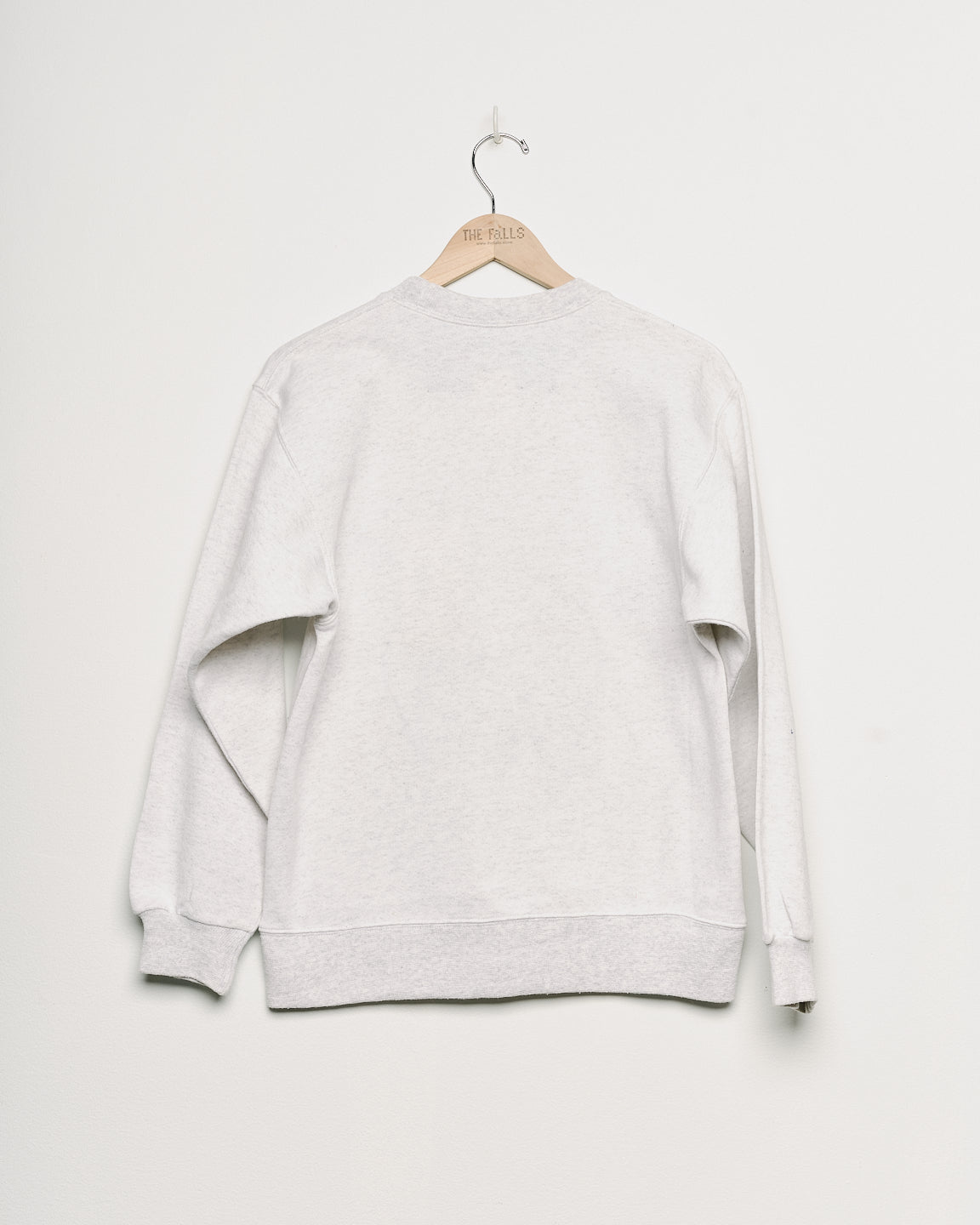 Upcycled sweatshirt with embroidery saying “hair force”, back view. 