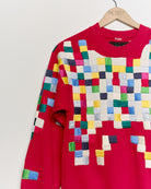 Upcycled sweatshirt with geometric embroidery, close up view. 