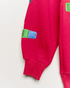 Upcycled sweatshirt with geometric embroidery, close up view. 