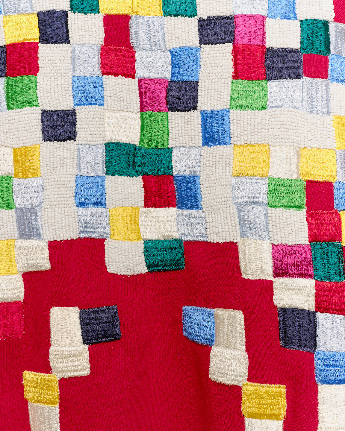 Upcycled sweatshirt with geometric embroidery, close up view. 