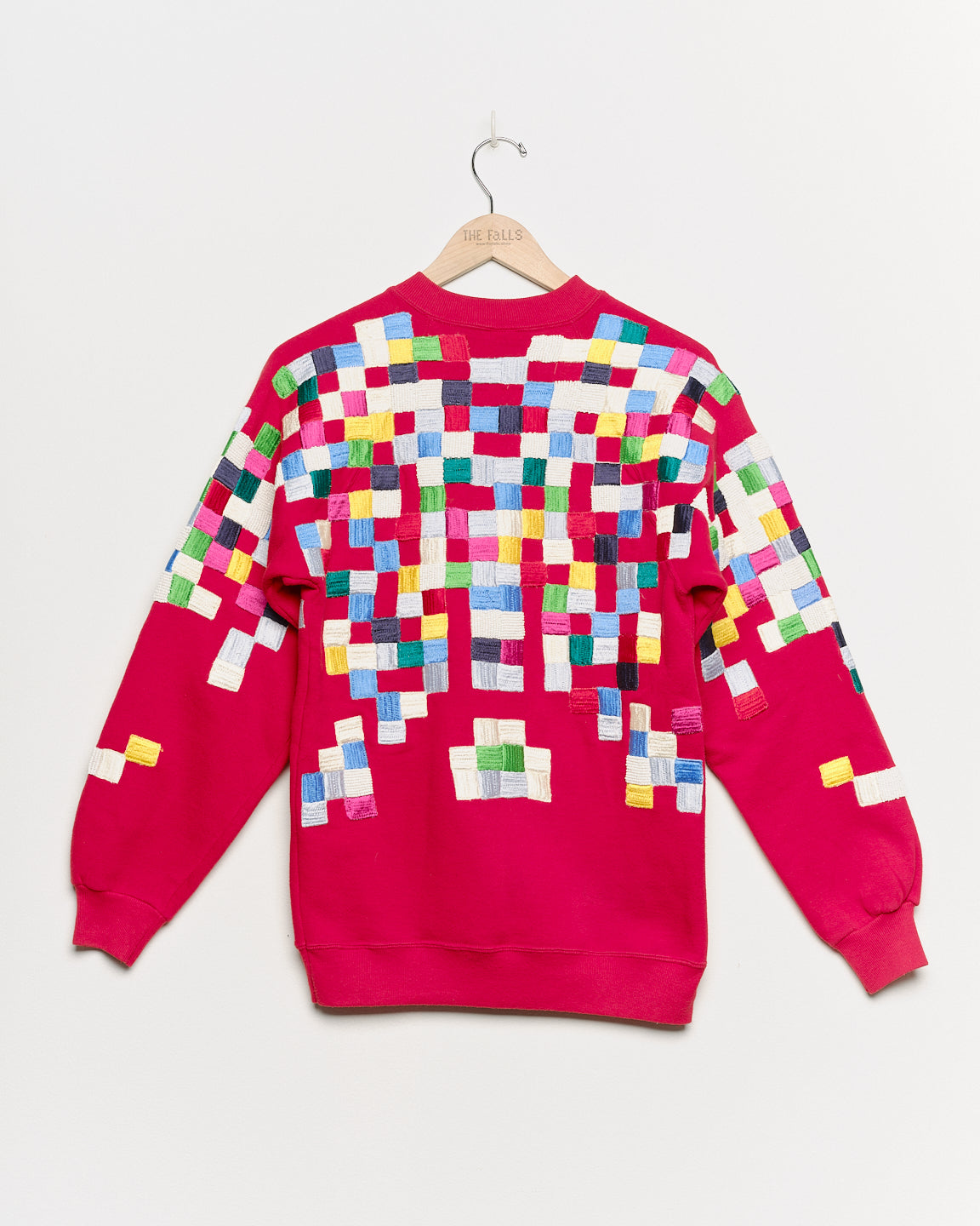 Upcycled sweatshirt with geometric embroidery, back view. 