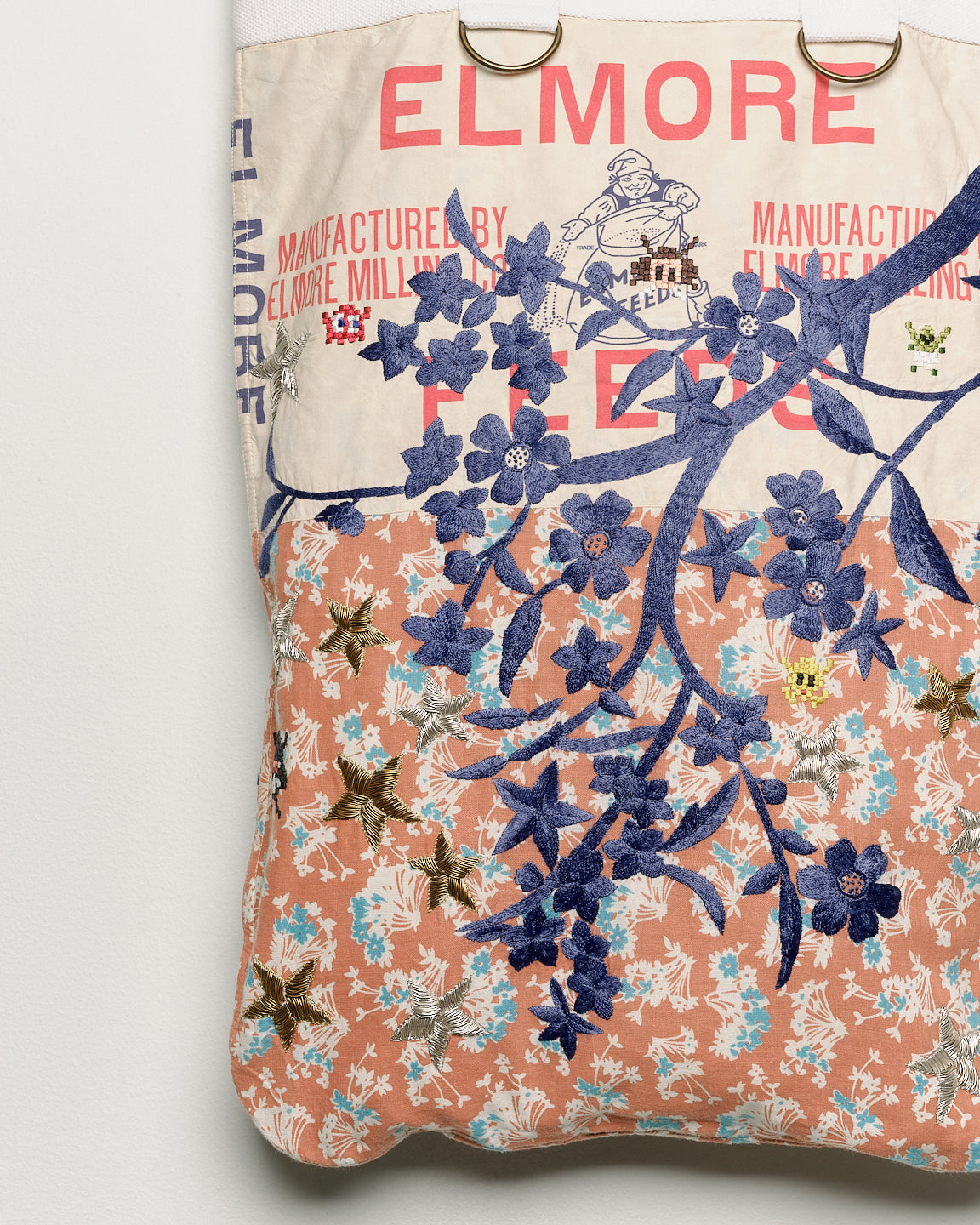Repurposed vintage feedback tote with embroidered florals, close up view. 