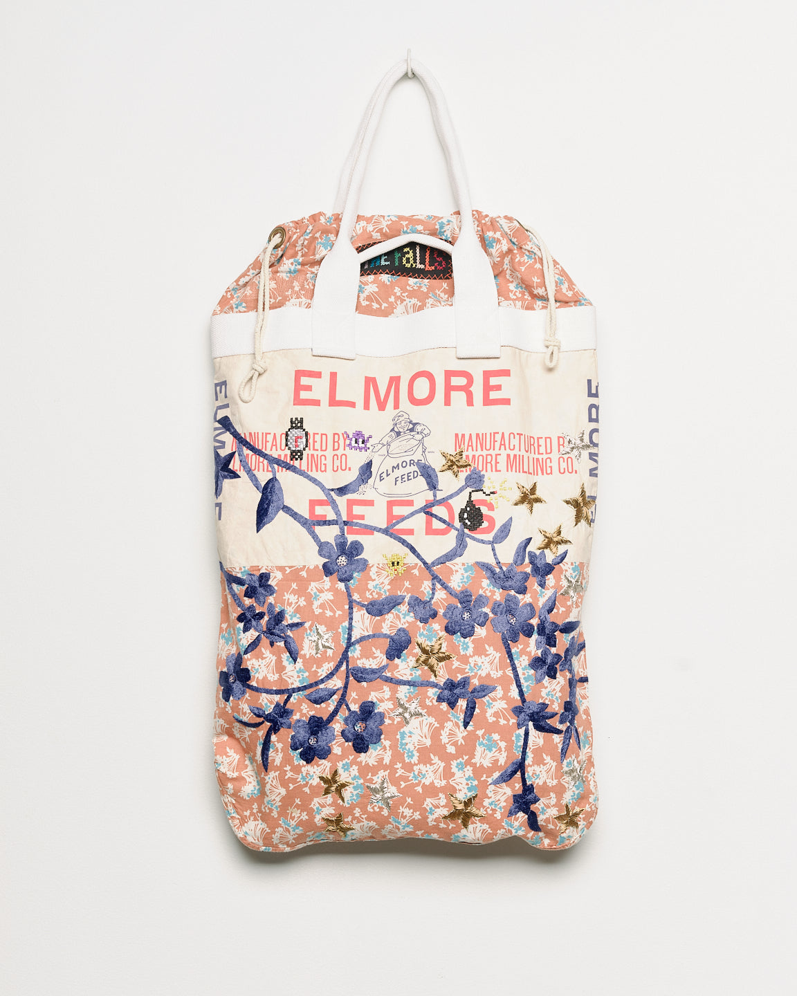 Repurposed vintage feedback tote with embroidered florals, back view. 