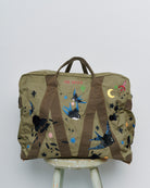 Upcycled aviator bag with embroidered embellishments, front view 