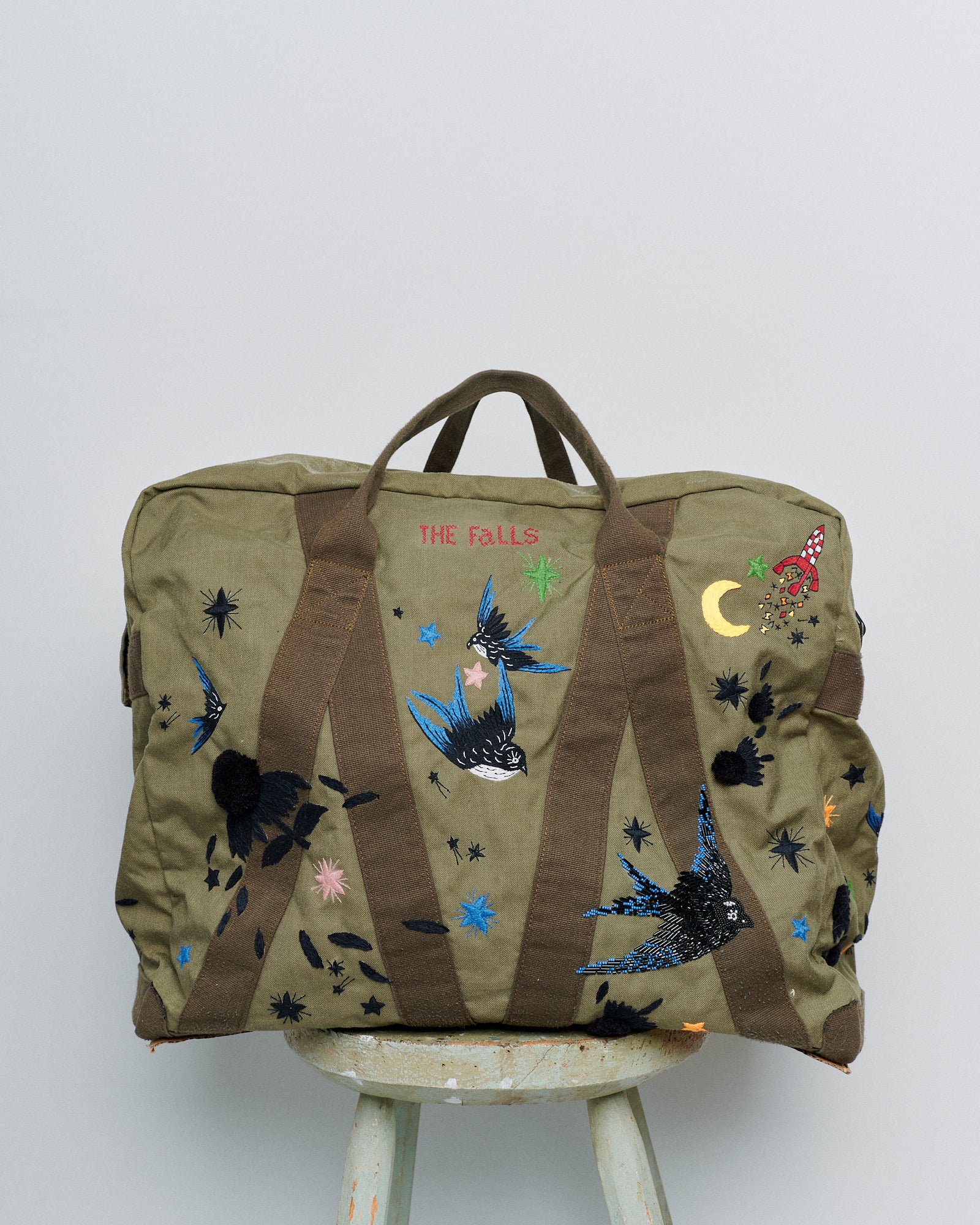 Upcycled aviator bag with embroidered embellishments, front view 