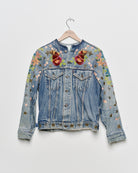 Vintage denim jacket with embroidery and tufted motifs, front view. 