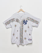 Upcycled baseball tee with embellishments, front view. 