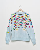 Upcycled sweatshirt with geometric embroidery, front view. 