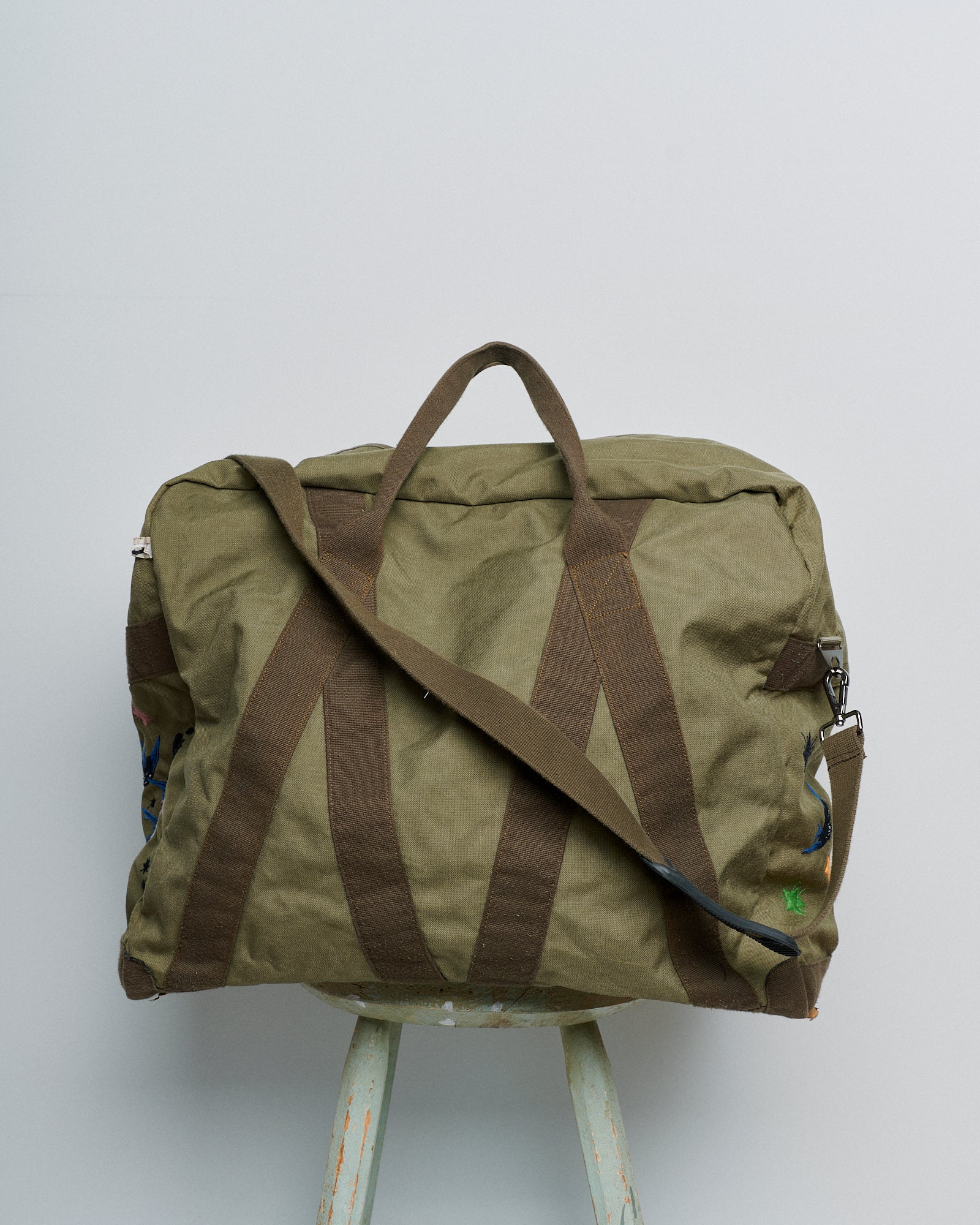 Upcycled aviator bag with embroidered embellishments, back view 