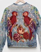 Vintage denim jacket with embroidery and tufted motifs, back view. 