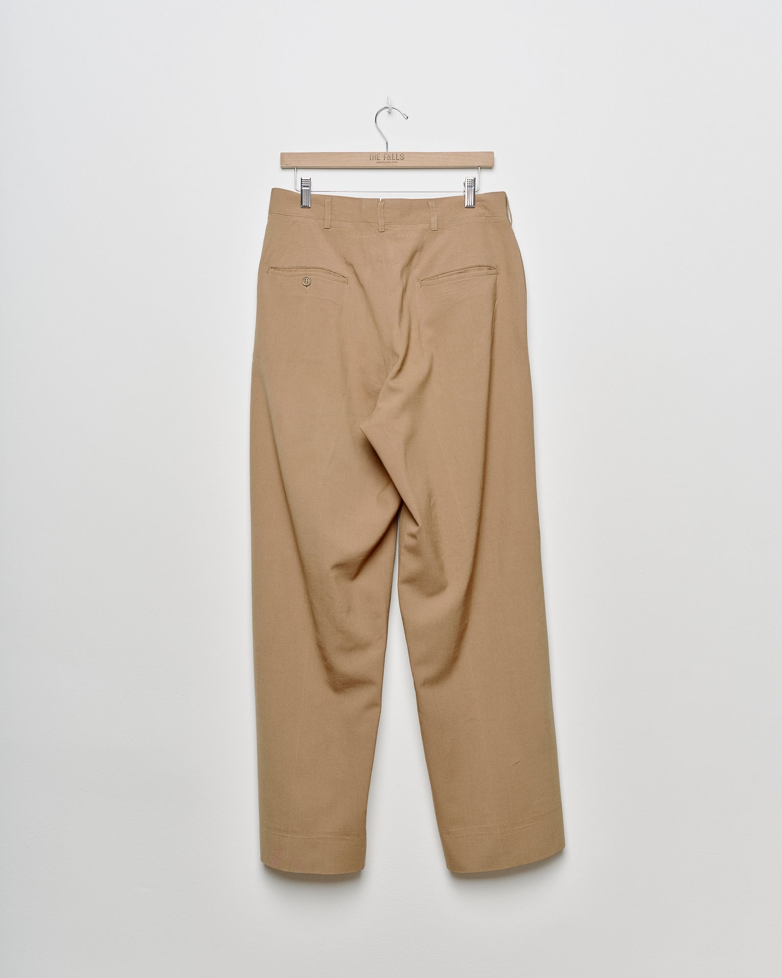 Upcycled wide leg khaki chino trousers with embroidered motif, back view.