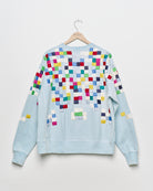 Upcycled sweatshirt with geometric embroidery, back view. 