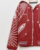 Red upcycled jacket with pearly buttons,
close up view.